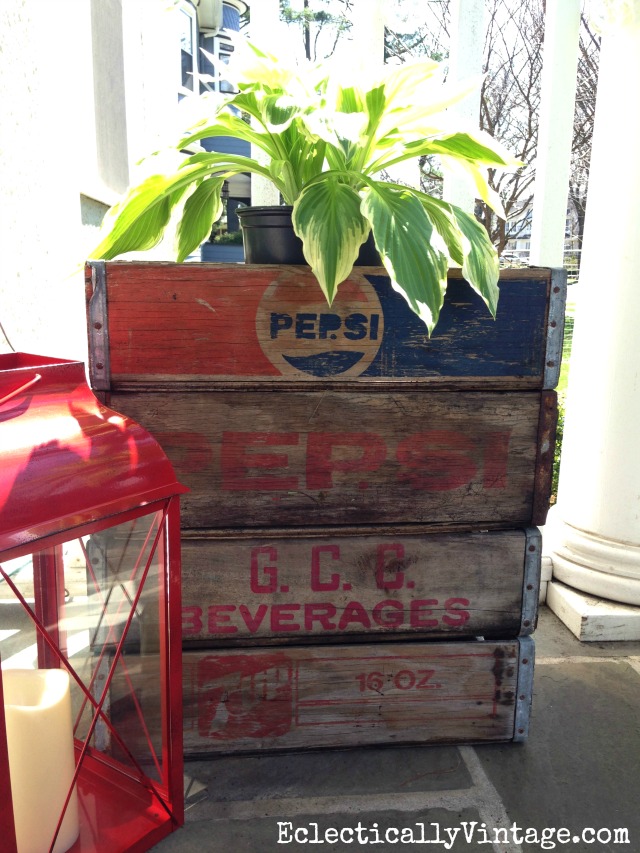 Love these vintage wood soda crates stacked on the front porch and holding plants kellyelko.com