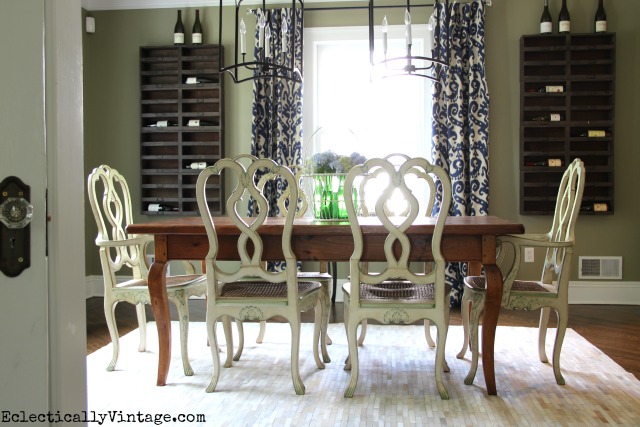 I love this dining room - the wine cubbies, the cowhide rug, the farm table ... kellyelko.com