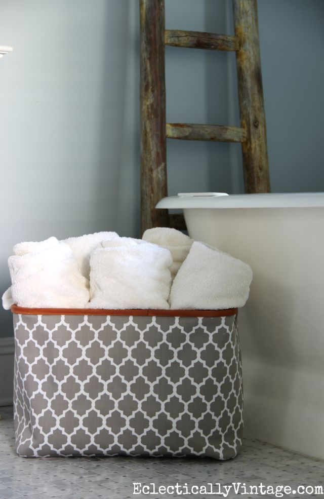 Love this storage idea - a big basket filled with bath towels kellyelko.com