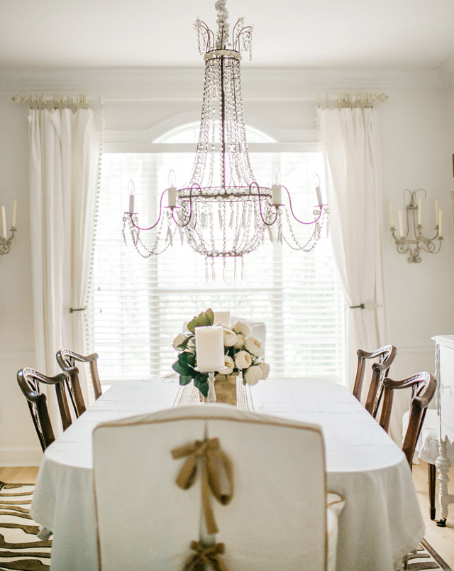 White dining room with glamorous crystal chandelier kellyelko.com