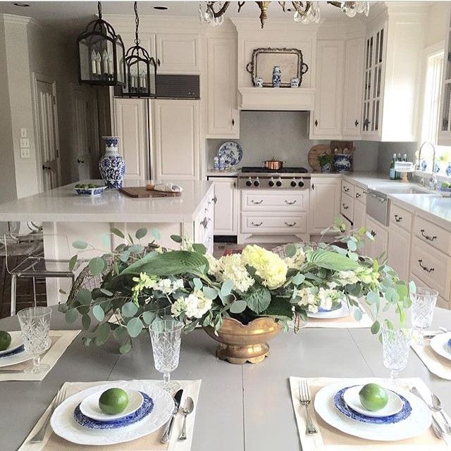 Gorgeous white kitchen - love the table set for dinner kellyelko.com