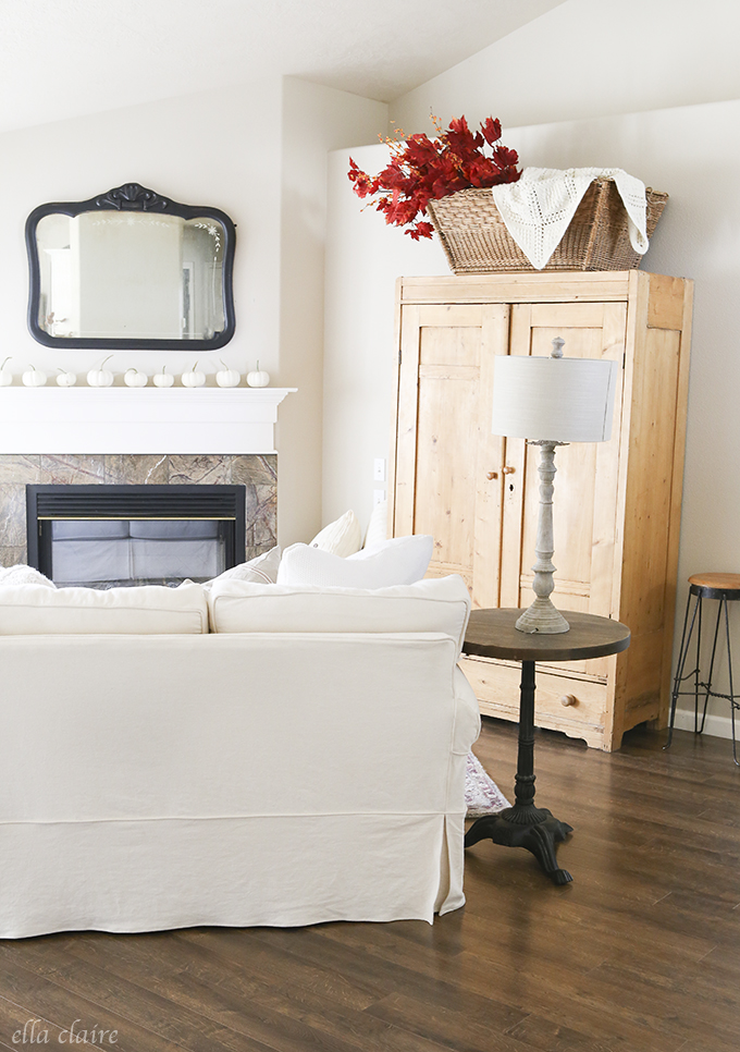 Neutral fall living room - love the bright red leaves in a basket 