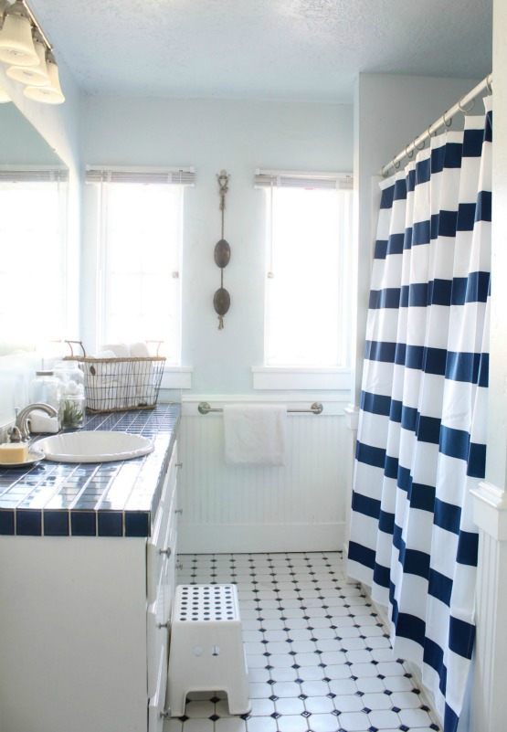 Blue and white bathroom - love the striped shower curtain