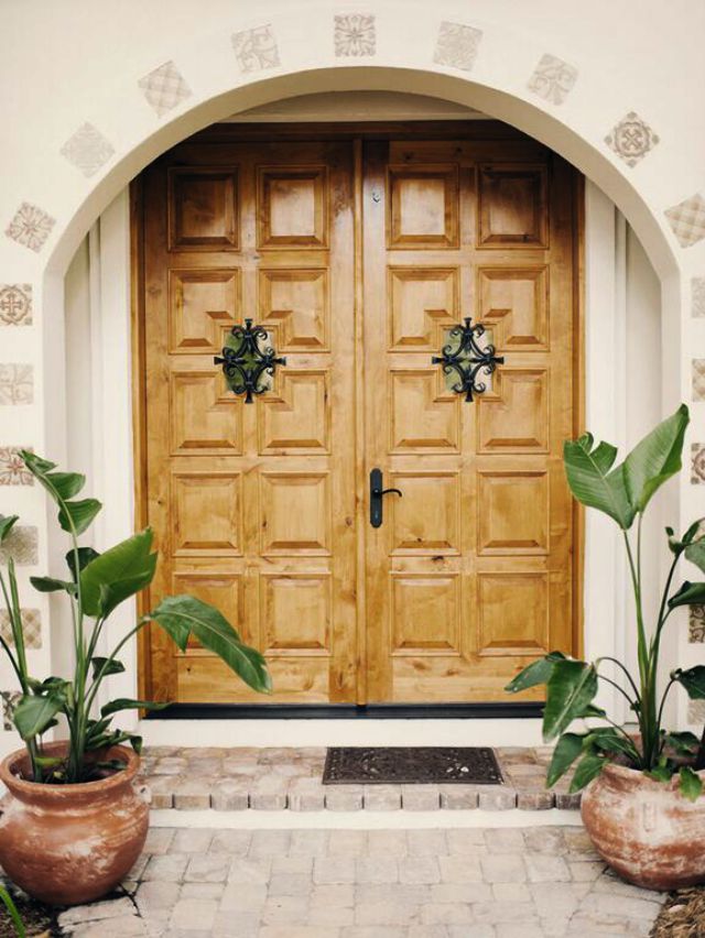 Love the Spanish influence in this house remodel and the double wood carved front doors with tile inlaid in the stucco kellyelko.com