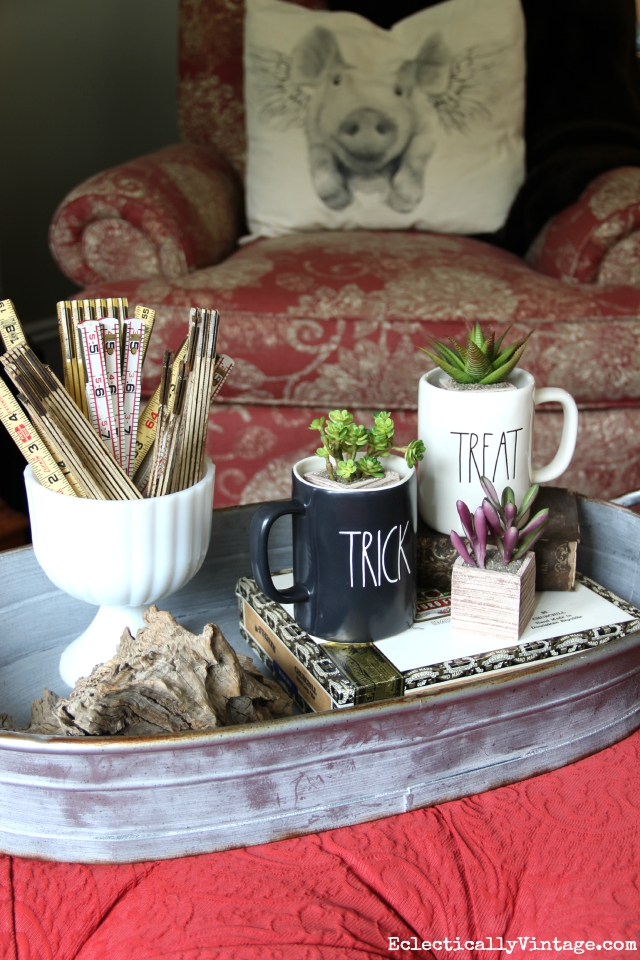 Fun fall coffee table display - love the Trick and Treat mugs filled with succulents kellyelko.com