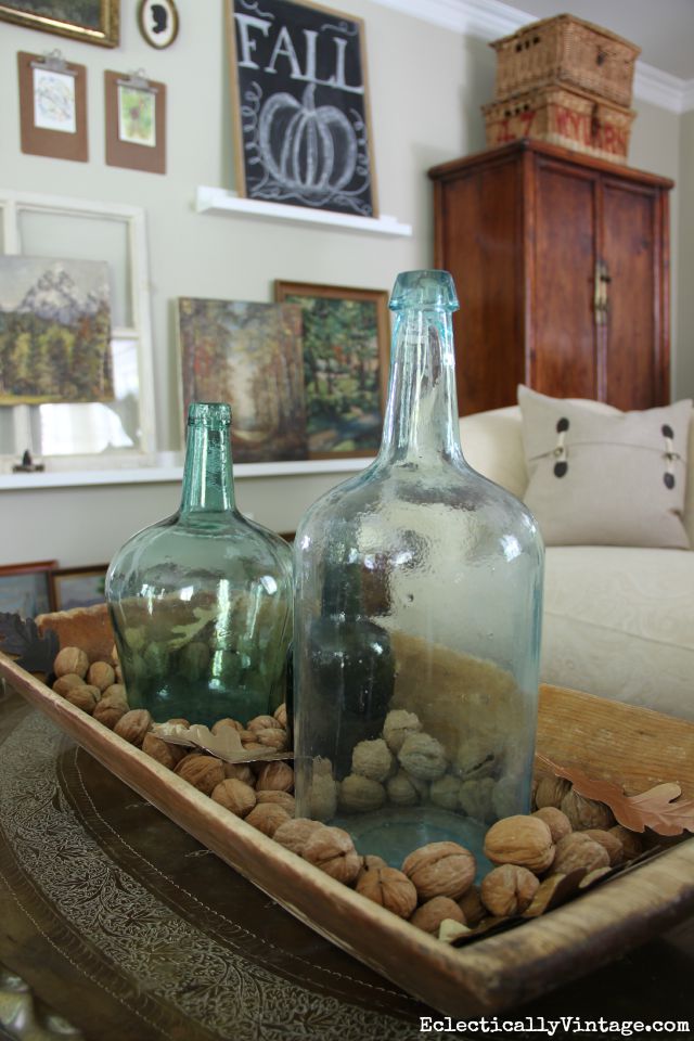 Love this vintage dough bowl filled with old glass bottles and look at that gallery wall! kellyelko.com