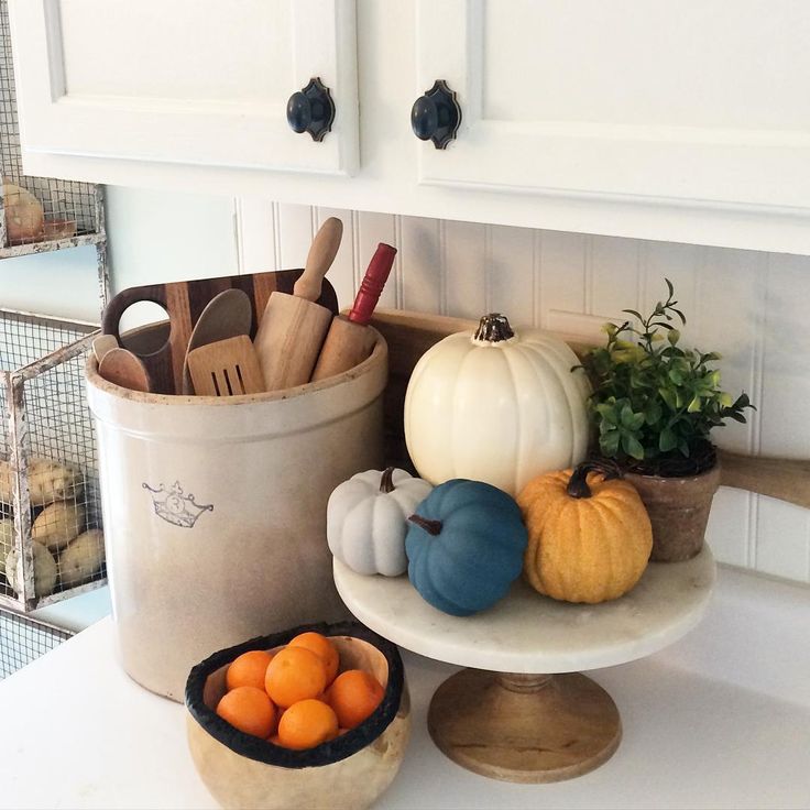 Fall kitchen - love the old crock filled with rolling pins and the pumpkins on a cake stand kellyelko.com