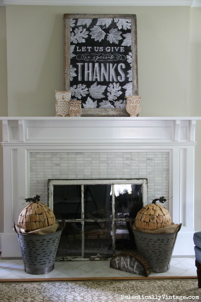 Love this neutral fall mantel, the vintage olive buckets holding driftwood pumpkins and that huge chalkboard printable kellyelko.com