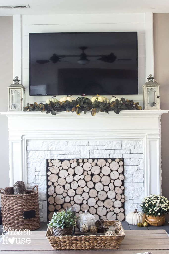 DIY faux mantel with log filled fireplace 