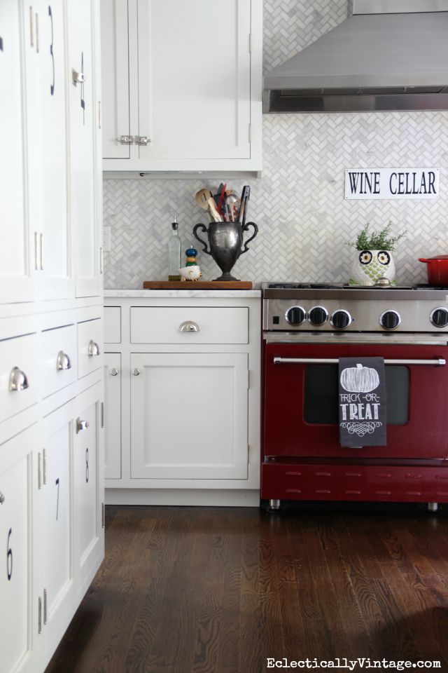 Red stove in a white kitchen - love the herringbone backsplash kellyelko.com