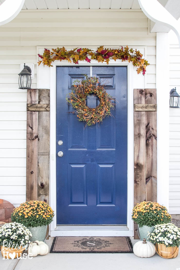 Rustic fall porch - love the blue front door and the shutters 