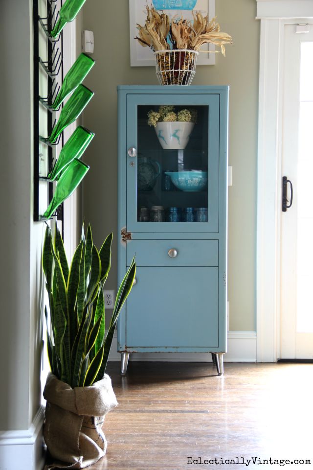 Love this vintage blue medical cabinet in the kitchen kellyelko.com