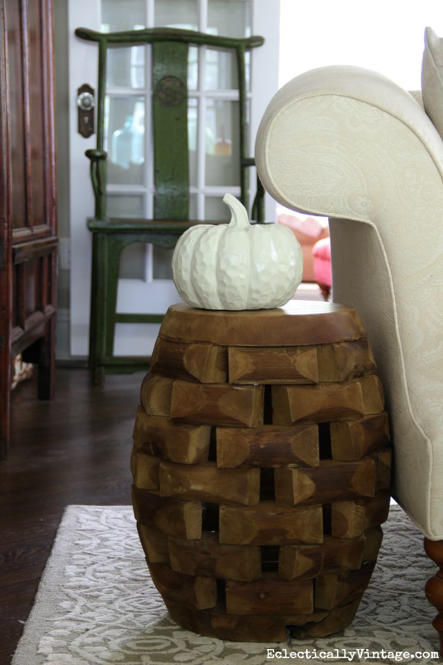 Love this little wood garden stool as an accent table kellyelko.com