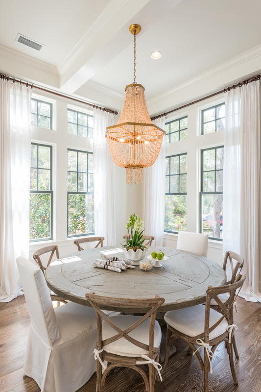 Love this breakfast nook and the rustic wood round table and chairs - take the full tour of this coastal home kellyelko.com