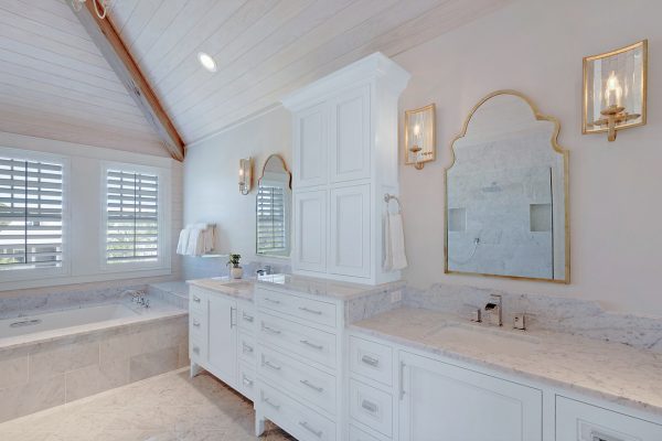 Carrara marble master bathroom - love the plank wood ceiling and the gold accents - part of this full coastal home tour kellyelko.com