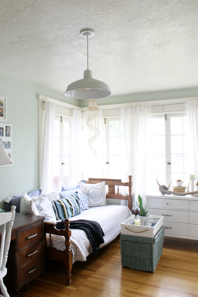 Beautiful sunroom with daybed and original window hardware 