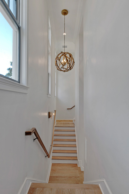 Driftwood orb chandelier in this beautiful coastal home - take the tour kellyelko.com