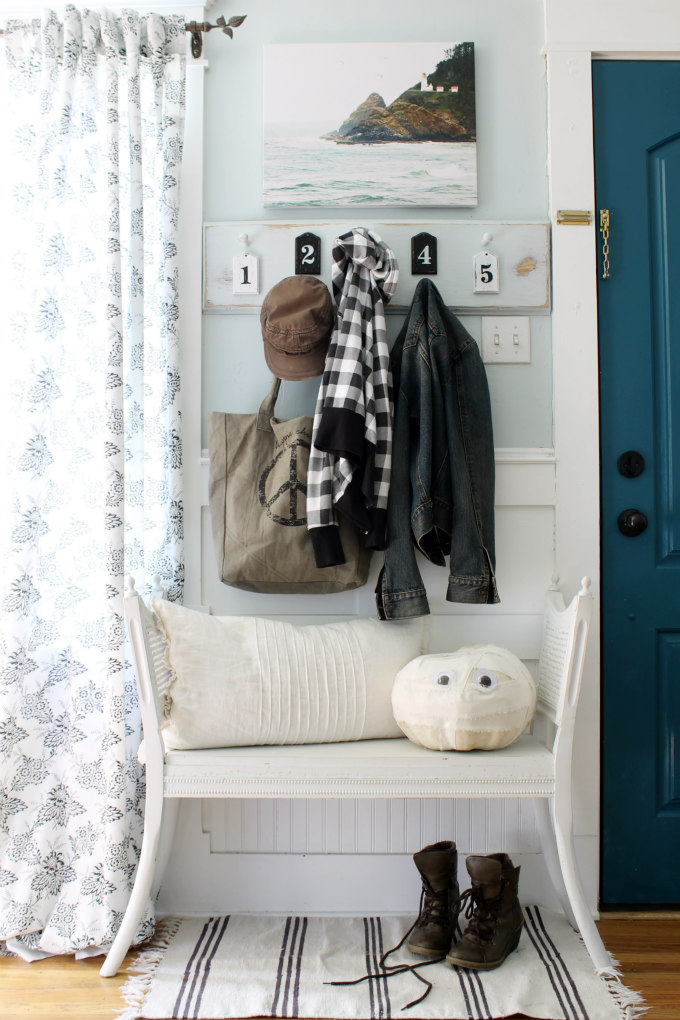 Love the numbered coat rack in this entry and the blue front door kellyelko.com