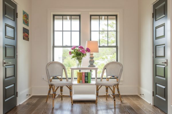 Love this pair of French bistro chairs and the black interior doors - tour this coastal home kellyelko.com