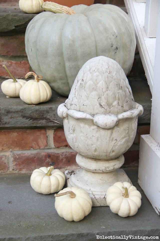 Add a garden finial and scatter some mini white pumpkins on a fall porch kellyelko.com