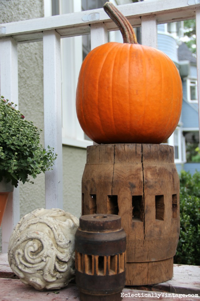 A few vintage finds and an orange pumpkin on a fall porch kellyelko.com