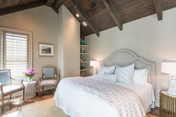 Love the dramatic wood beam ceiling and the upholstered headboard - take the full tour of this coastal home kellyelko.com