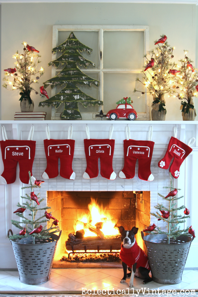 Love this whimsical mantel with long john stockings! The red car and tree theme is so festive! Tons of creative Christmas decorating ideas kellyelko.com