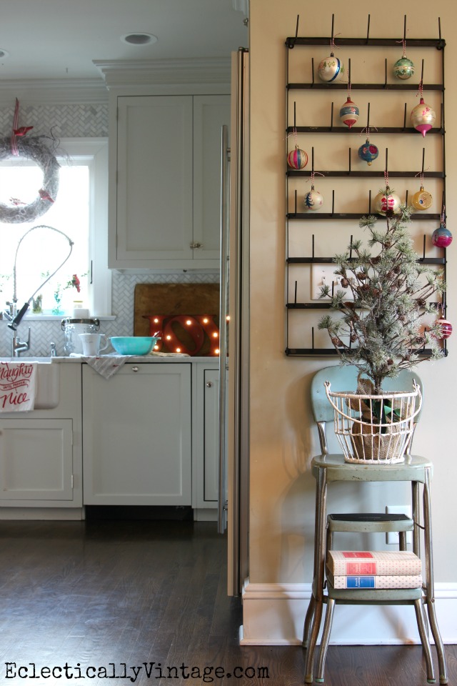 Vintage ornament display on a bottle drying rack - fun Christmas kitchen decor kellyelko.com