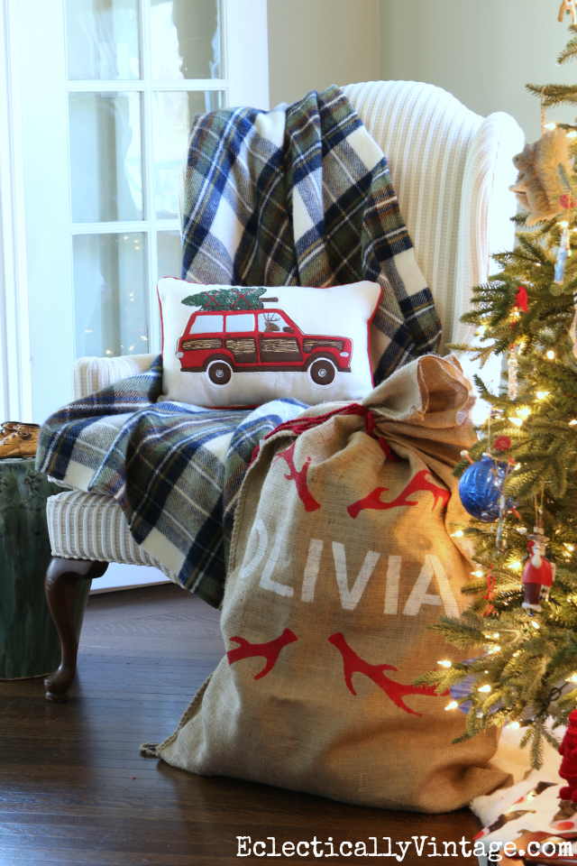 Cozy Christmas chair - love the blue plaid throw and the car carrying tree pillow kellyelko.com