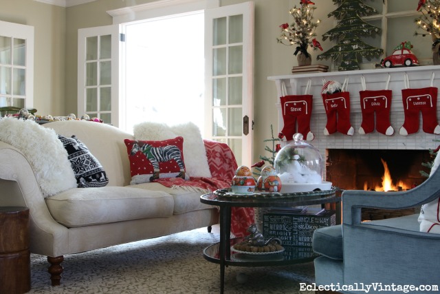 Christmas living room - love the festive pillows and whimsical mantel kellyelko.com