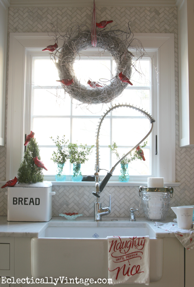 Festive Christmas kitchen window - love the white twig wreath and the cardinals kellyelko.com