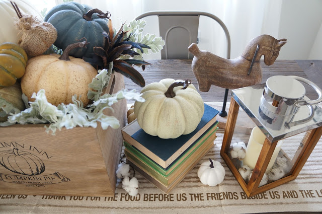 Beautiful fall tablescape - love the pumpkins on the stacked books kellyelko.com