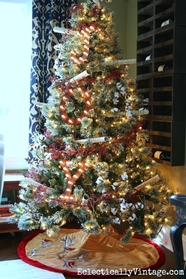 Love this flocked Christmas tree in the dining room and the JOY marquee sign on it kellyelko.com