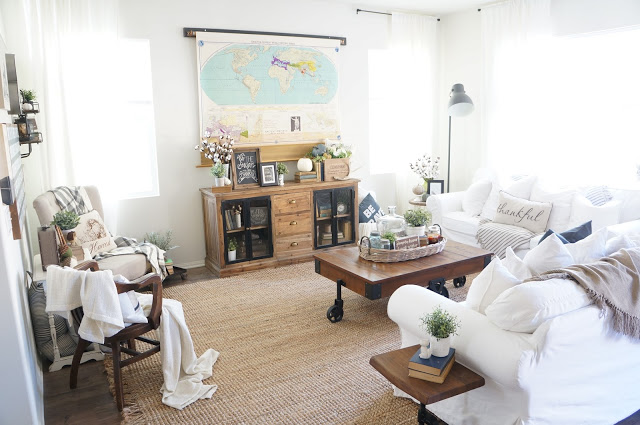 Beautiful neutral living room with map that hides the TV kellyelko.com