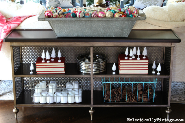 Console table shelves decked out for Christmas - love the huge zinc trough filled with vintage ornaments kellyelko.com