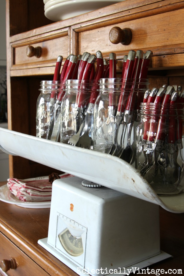 Red cutlery in mason jars on a vintage scale kellyelko.com
