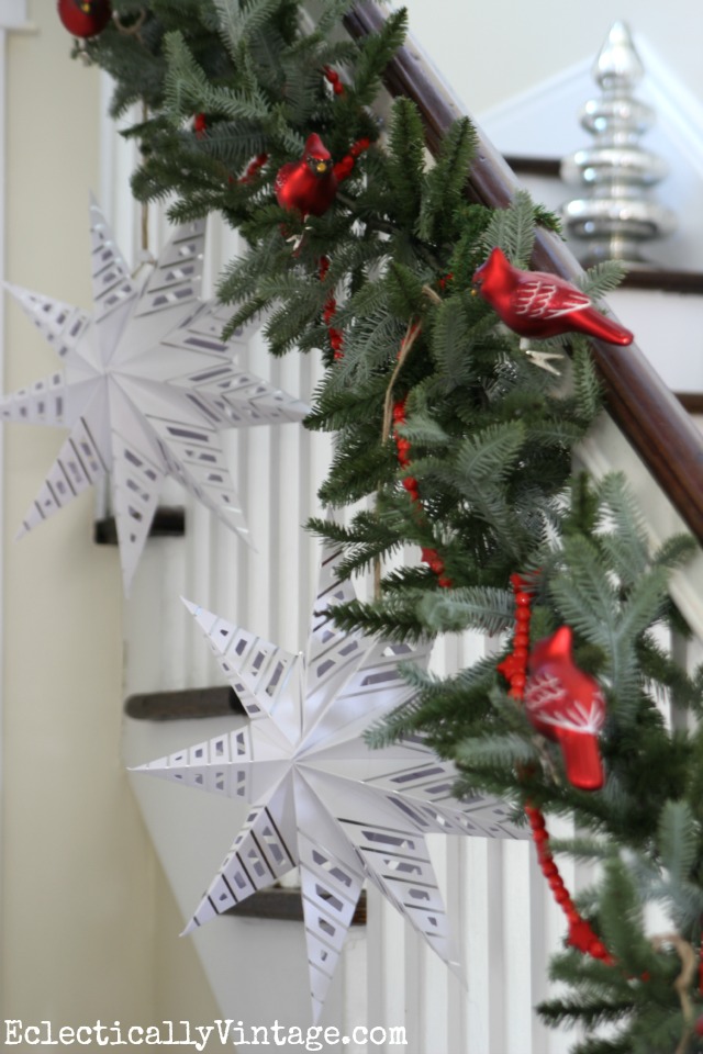 Love these huge paper stars hanging from this Christmas bannister kellyelko.com