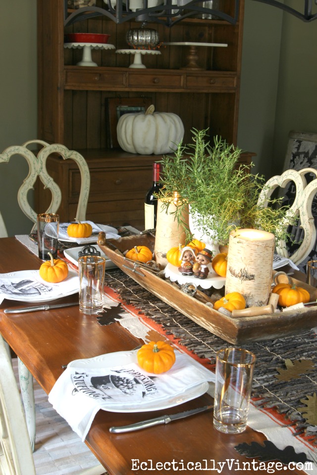 Beautiful Thanksgiving table - love the dough bowl centerpiece, twig runner and fun napkins! kellyelko.com