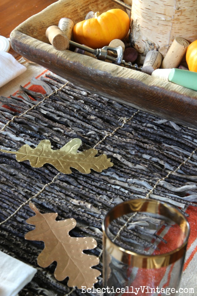 Love the texture of this twig table runner and the DIY metal leaves are perfect for a fall table kellyelko.com