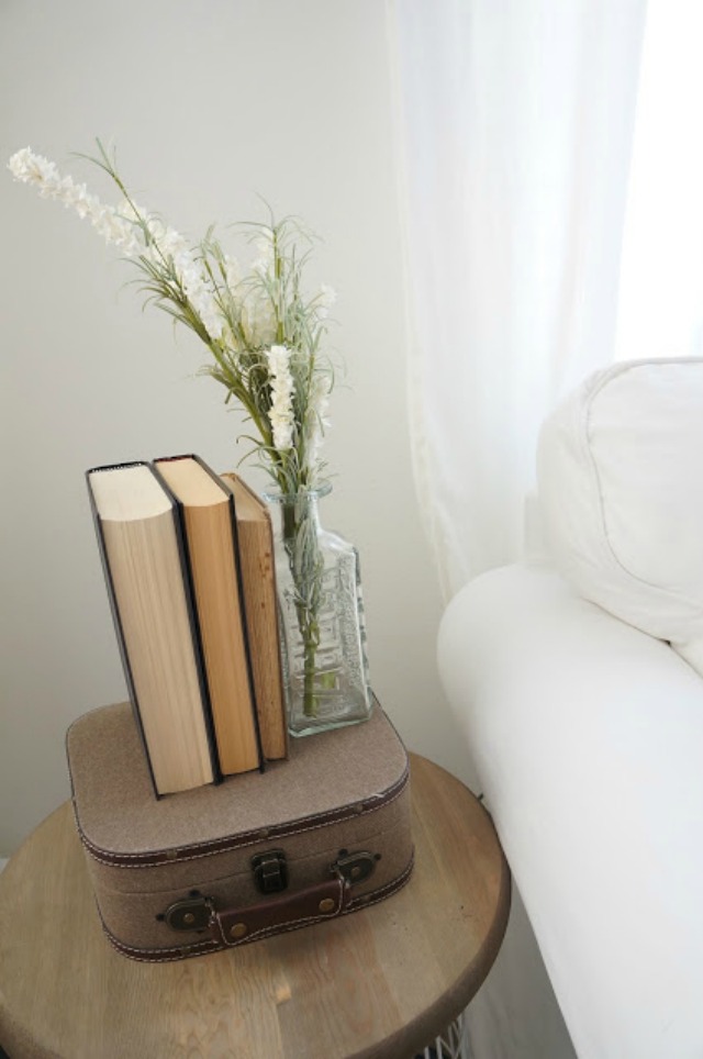 Vintage book display on a cute little suitcase - lots of affordable decorating ideas in this home tour kellyelko.com