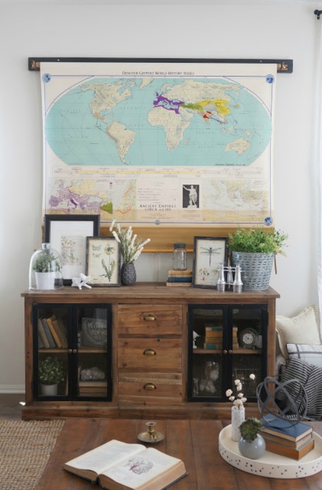 Love this idea - a vintage pull down map covers the TV kellyelko.com