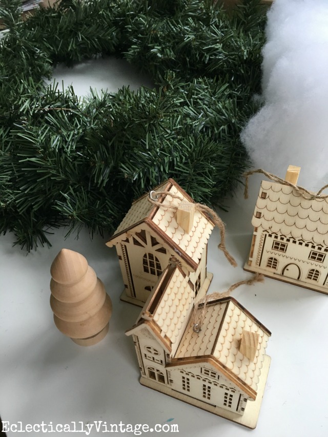Make a winter village wreath with these cute wood ornaments kellyelko.com