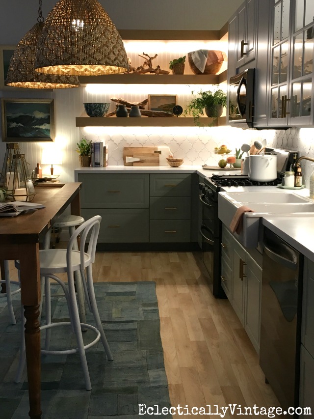Love this eclectic, beachy kitchen with wood door island and open shelving kellyelko.com