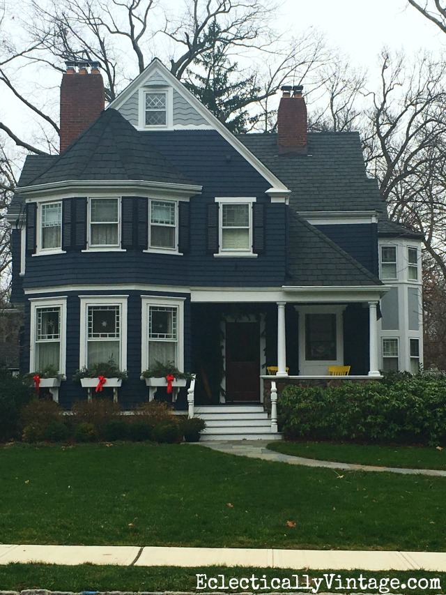 Love the Christmas window boxes filled with fresh greens and red bows kellyelko.com