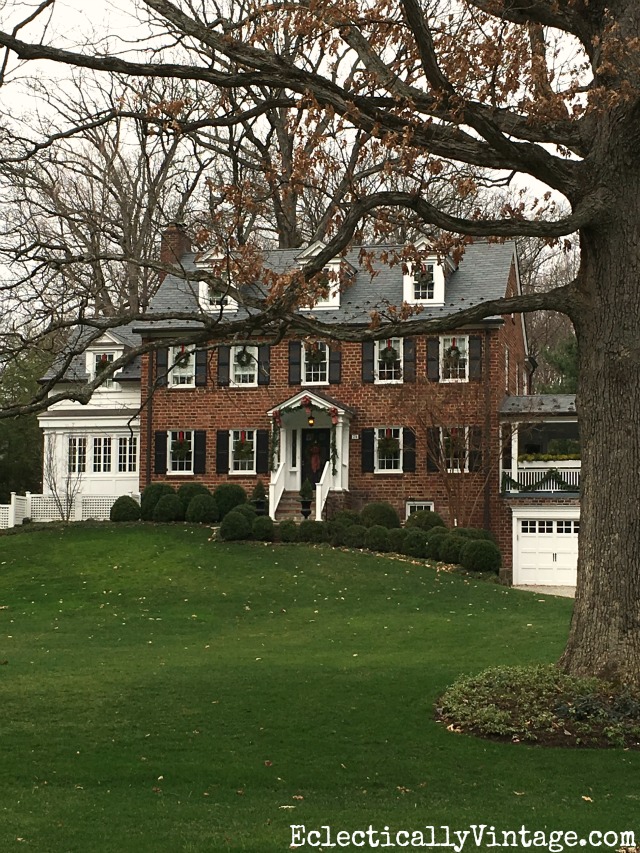 Brick house at Christmas - love the wreaths on every window kellyelko.com