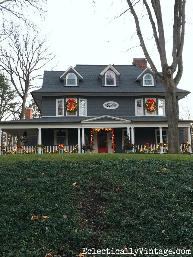 Christmas house - love the big porch with garland and red bows kellyelko.com