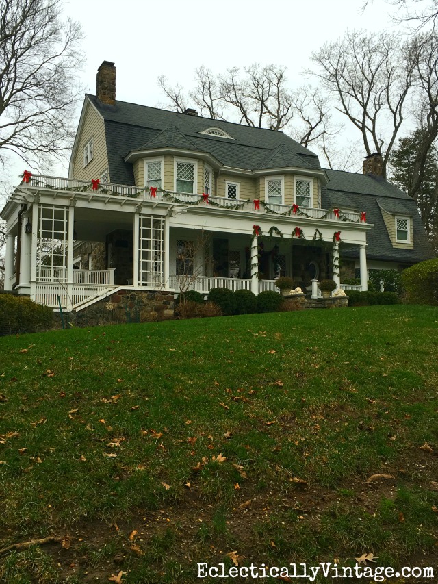 Love fresh garland and red bows on a Christmas house kellyelko.com