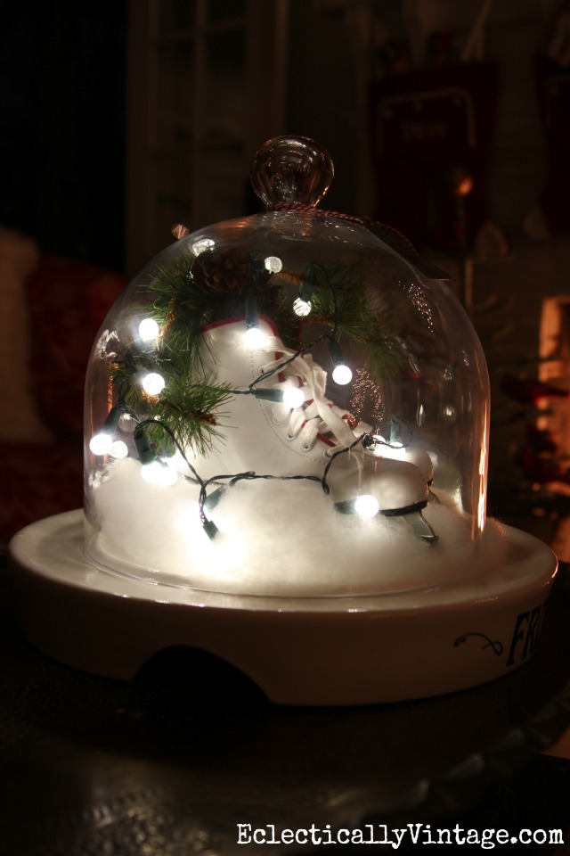 Ice skates and string lights under a cloche kellyelko.com