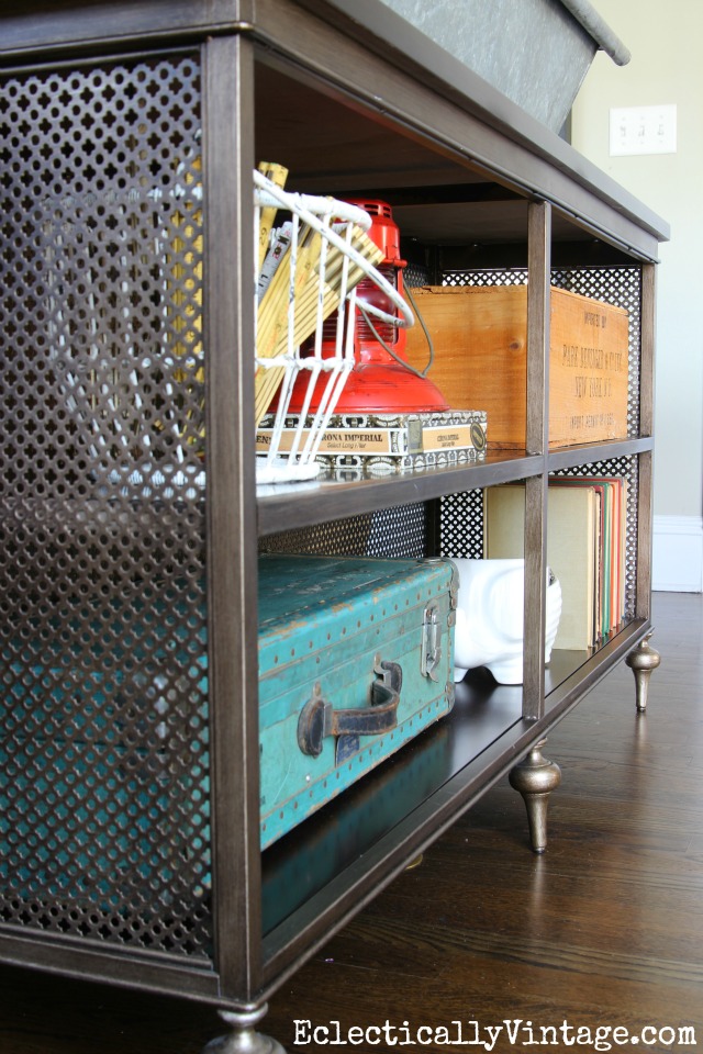 I love this console table with open metal fretwork and lots of fun vintage finds on display kellyelko.com