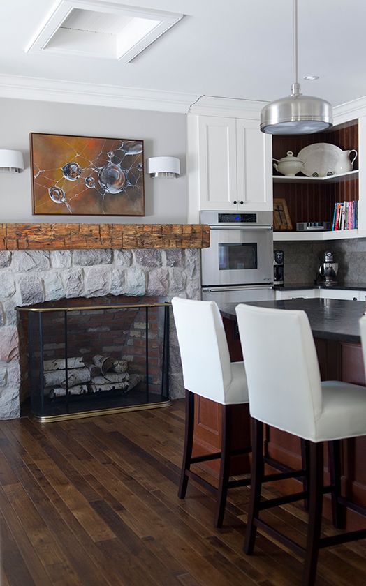 Love this farmhouse with a fireplace in the kitchen! The rustic beam mantel is stunning kellyelko.com